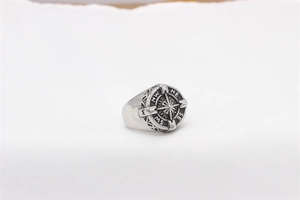 Detailed view of vintage nautical compass relief on a silver stainless steel men's ring