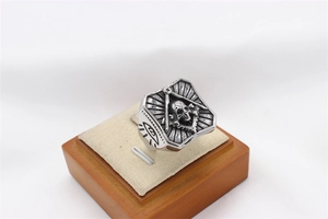 Macro detail of vintage Freemason skull ring in silver steel with All-Seeing Eye engraving