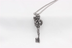 Macro shot of vintage dragon key pendant with intricate engraving and 200 marking