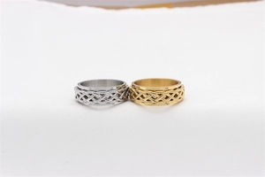 Detail of gold and silver spinner rings featuring intricate Celtic knot patterns on steel