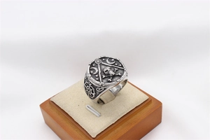 Detailed engraving of gothic skull and masonic symbols on vintage steel ring