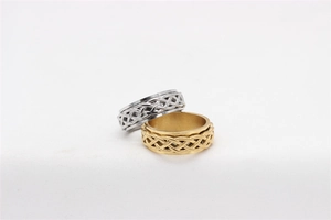 Detail of gold and silver spinner rings with intricate Celtic knot hollow pattern