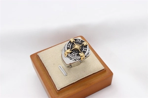 Detailed close-up of a vintage compass signet ring with gold accents and side engraving