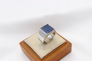 Macro view of men's titanium steel ring with square blue lapis lazuli gemstone inlay