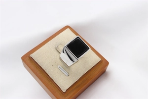 Macro shot of men's square black gemstone ring with polished silver stainless steel band