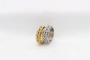 Detailed view of gold and silver spinner rings with Celtic knot patterns in stainless steel