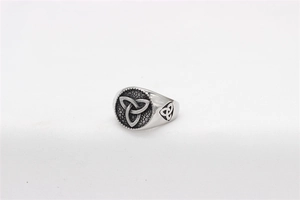 Detail view of vintage Celtic Triquetra knot engraved on a stainless steel Viking ring