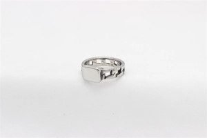 Detail of silver chain ring with smooth rectangular stamp on white fabric background