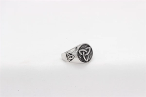 Macro shot of silver Viking ring with Celtic Triquetra knot and granulated texture