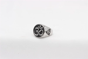 Macro shot of vintage titanium steel ring featuring engraved spiritual Om symbols
