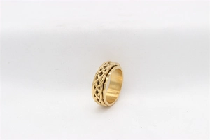 Detailed close-up of a gold-plated titanium steel spinner ring with Celtic knot patterns