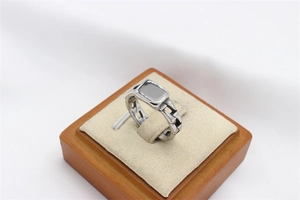 Detailed view of silver stainless steel ring featuring a flat top and chain link band