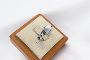 Macro view of silver titanium steel ring with cuban chain design on display stand