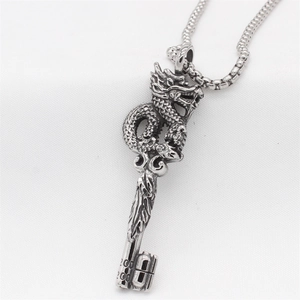 Vintage steel dragon key pendant necklace with detailed scales on white background