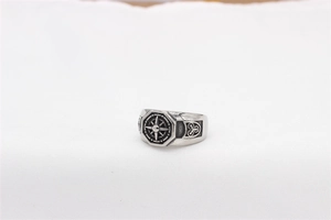 Macro shot of retro stainless steel men's ring with compass pattern and rope texture