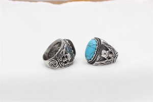 Detail of gothic punk rings with skull engraving and turquoise gemstone inlays