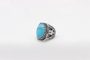 Detail of vintage eagle embossed silver ring with a blue oval turquoise gemstone
