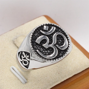 Vintage silver stainless steel men's ring featuring an embossed Om symbol on black texture