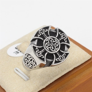 Macro view of vintage stainless steel Viking Celtic knot ring with cross pattern and aged finish