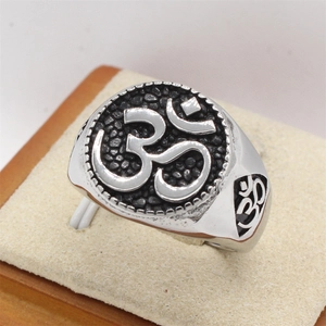 Polished silver titanium steel ring with Om symbol on black textured signet face