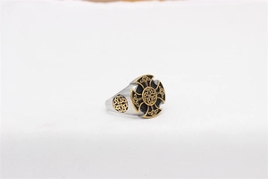 Detail view of vintage Viking signet ring featuring a gold Celtic knot on black cross