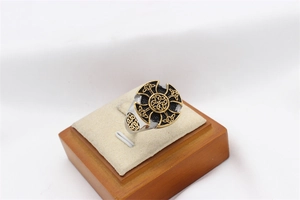 Macro view of vintage Viking ring featuring Celtic cross and intricate gold knot details