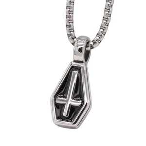 Macro view of Gothic coffin pendant necklace with black enamel inverted cross