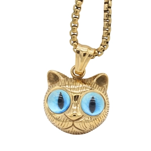 Vintage gold cat pendant necklace with striking blue eyes and detailed texture on box chain