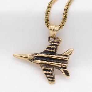 Retro fighter jet pendant necklace in vintage gold finish with detailed metal engraving