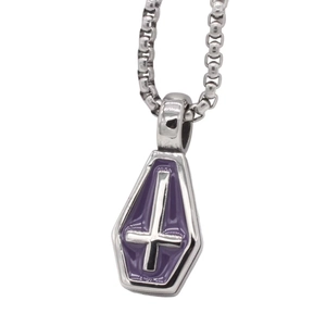 Macro view of gothic coffin pendant necklace with purple enamel and silver cross detail