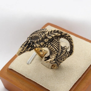 Retro stainless steel ring with detailed dinosaur scale engraving on jewelry stand