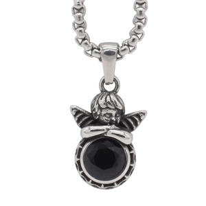 Macro shot of retro silver angel pendant with round faceted black gemstone and chain