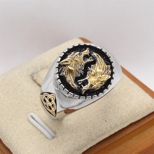 Close-up of Viking wolf head signet ring with gold relief and Celtic knot patterns