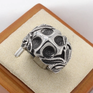Vintage gothic men's ring featuring cross and skull embossed textures in silver finish