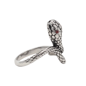 Detailed view of vintage steel snake ring with red crystal eyes and scale texture