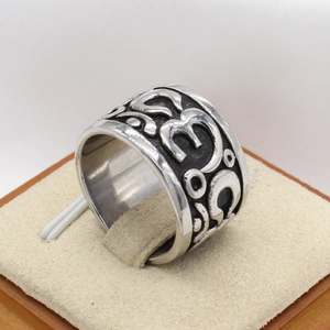 Retro stainless steel wide band ring with embossed mantra symbols for men on stand