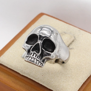 Retro punk style stainless steel skull ring for men with a polished silver metallic finish