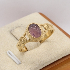 Vintage gold-plated stainless steel ring with oval purple gemstone and swirl carvings