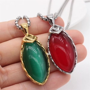 Detail of vintage palace style pendant necklace with marquise cat eye stone and steel chain
