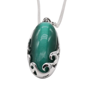 Elegant oval green cat-eye stone pendant with silver filigree scrollwork on snake chain