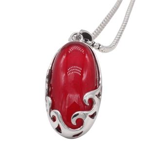 European style vintage necklace featuring a red oval gemstone pendant on a silver snake chain