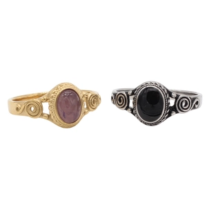 Detail showing vintage hollowed rings with pink and black stones and spiral carvings
