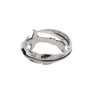 Macro detail of vintage silver sword ring featuring intricate feather carvings and dark patina