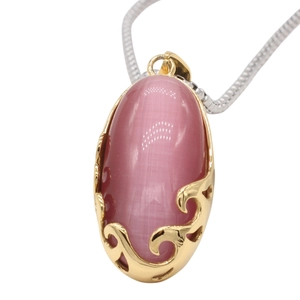 Elegant gold oval pendant with pink cat eye stone and wavy filigree on silver chain