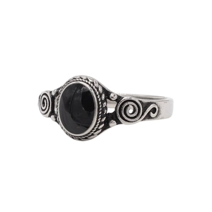Detail of vintage silver titanium steel ring featuring an oval black gemstone and spiral patterns