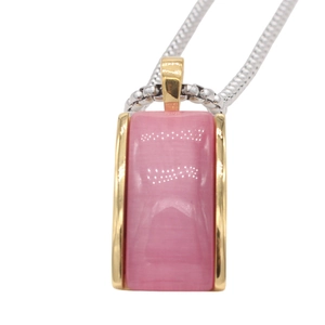 Detail of a pink rectangular stone pendant with gold trim and silver snake chain