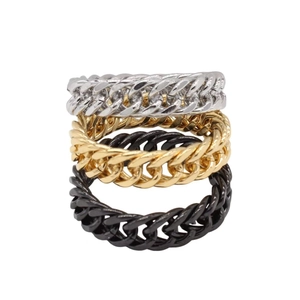 Detailed view of silver gold and black Cuban link chain rings in stacked arrangement