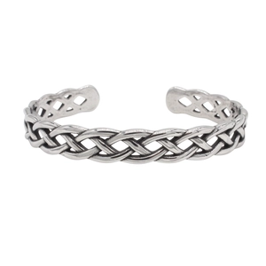Detail of vintage silver titanium steel cuff featuring intricate Celtic woven design