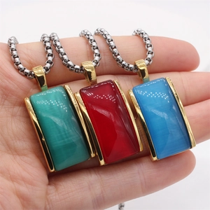 Detailed view of rectangular gemstone pendants in red, blue, and green on silver chains