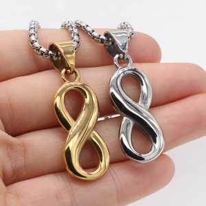 Retro infinity symbol pendant necklace in gold and silver finish on hand